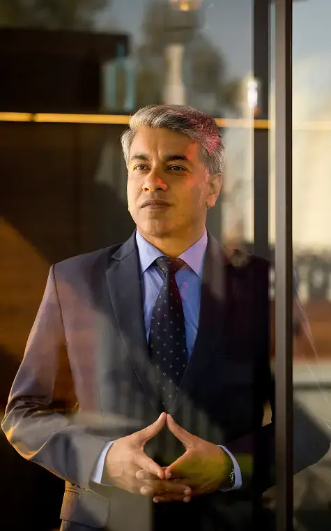 Businessman at window flashing a hedgefund gang sign