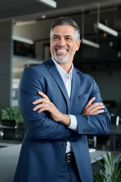 CEO type with arms folded in 3/4 profile with a blue suit, smiling and why do I sound like I'm just writing the prompt that was used to generate this pic?